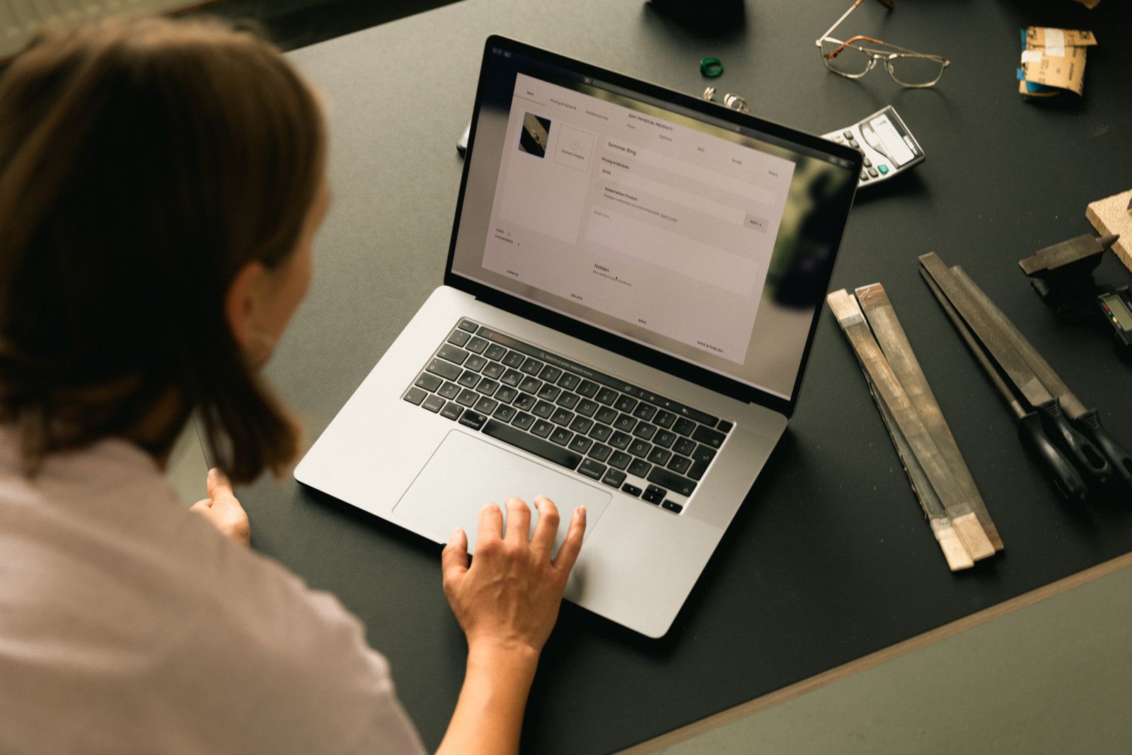 Woman shopping online on a laptop at a desk
